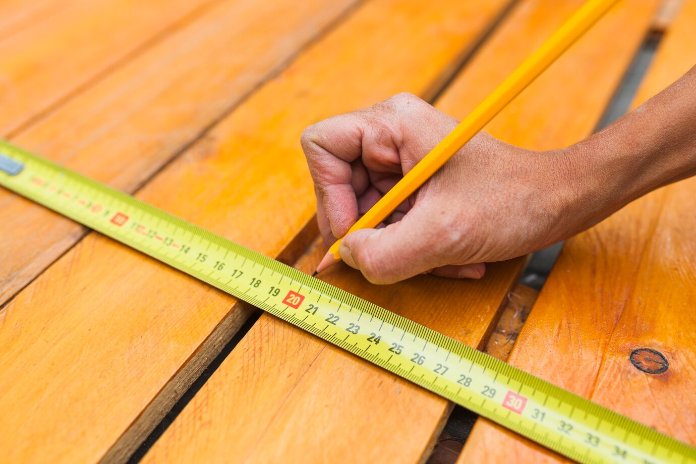 Hand with ruler and pencil